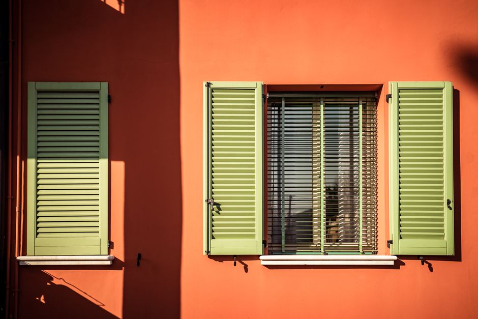 Painted door and wall of a house in sunlight