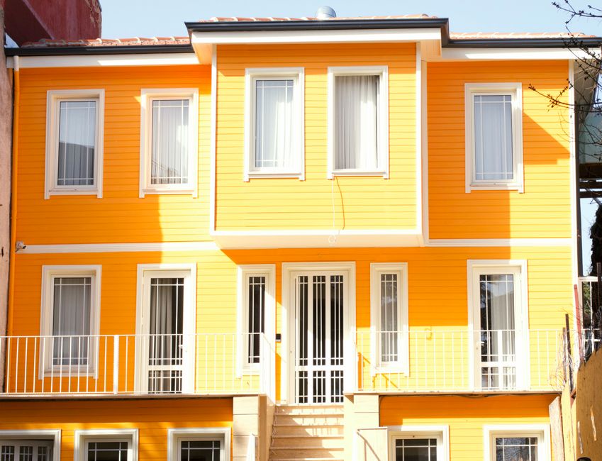 Colourful painted house front under a clear sky