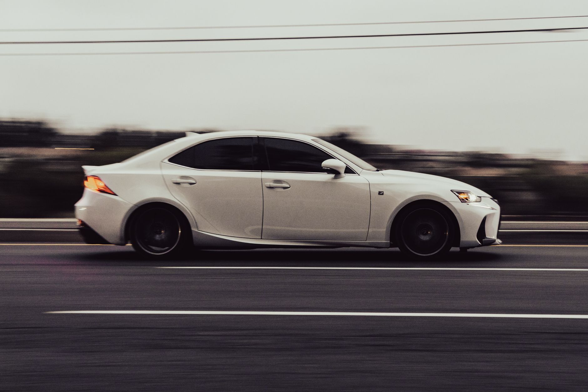 Dynamic shot of a white car speeding on Temecula highway
