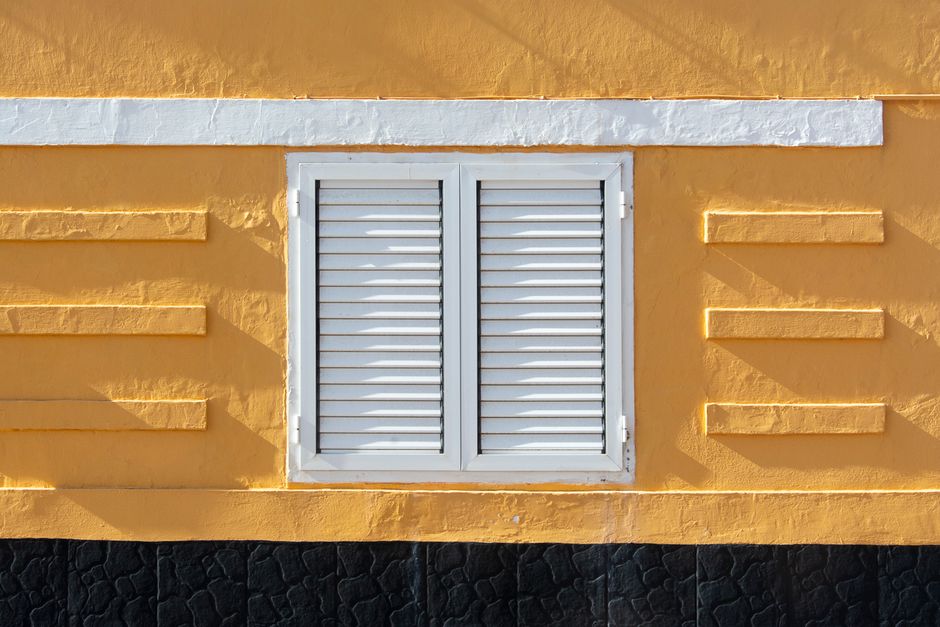 Colourful painted house front under a clear sky